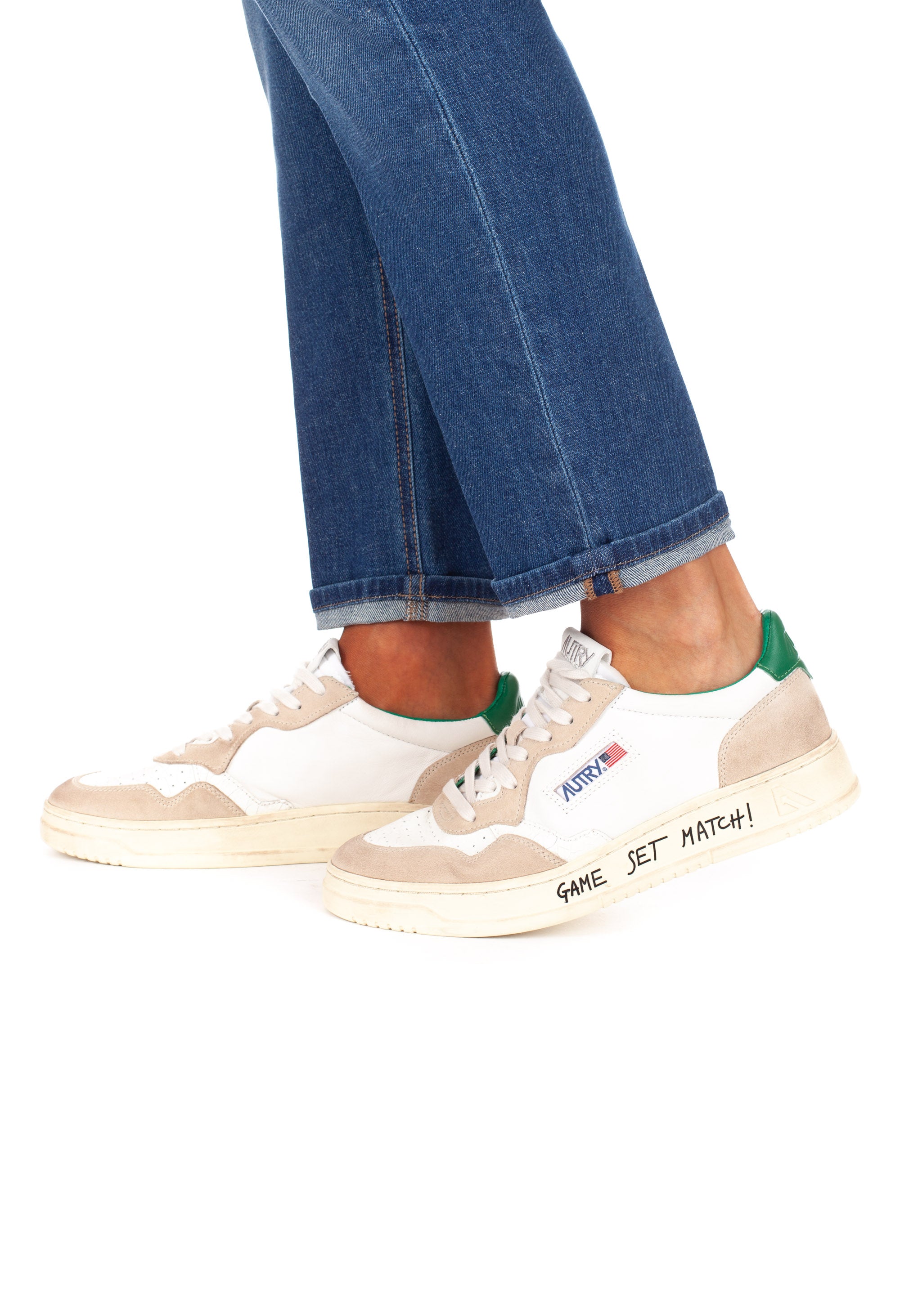 Medalist sneaker with green heel tab and writing