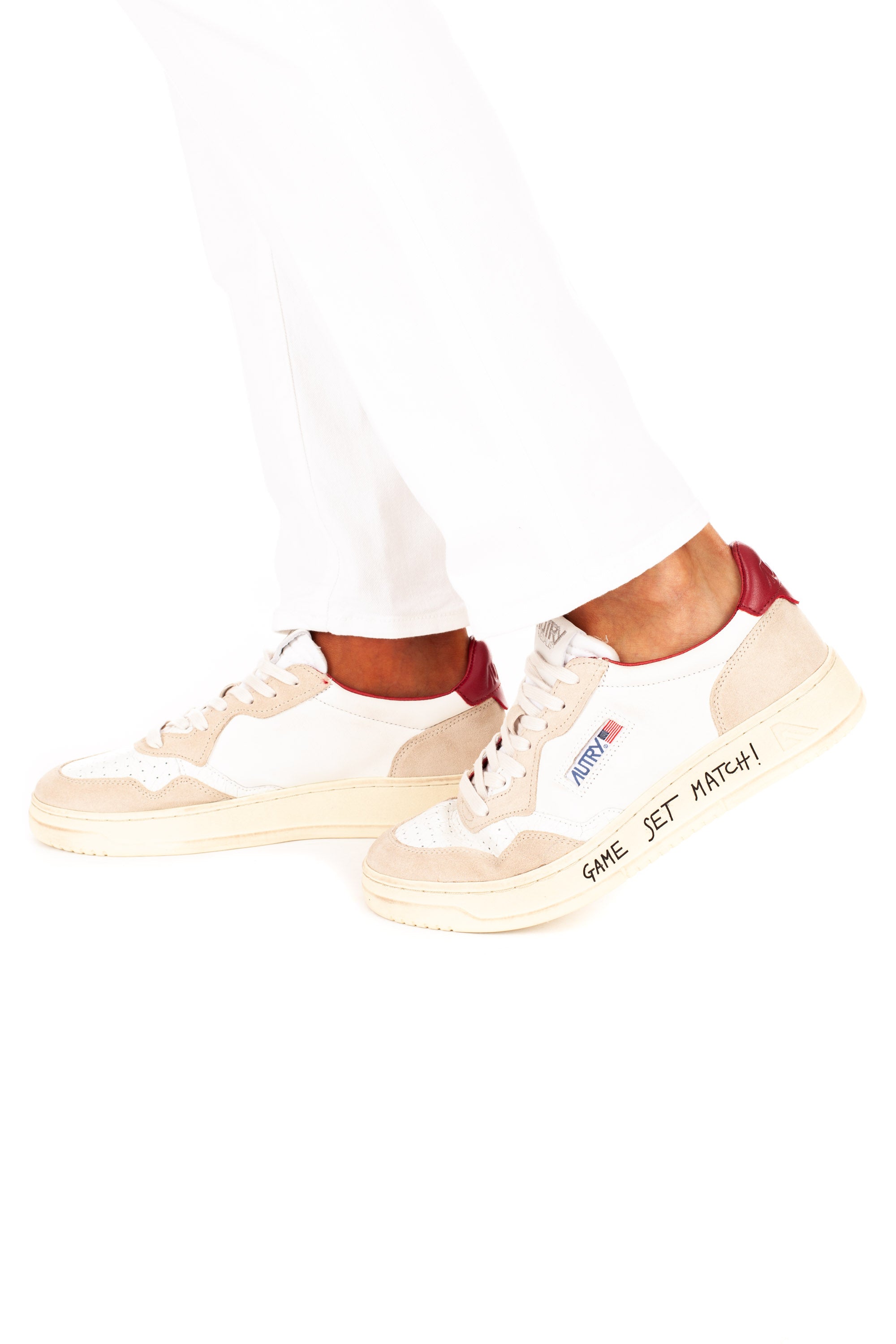 Medalist sneaker with red heel tab and writing